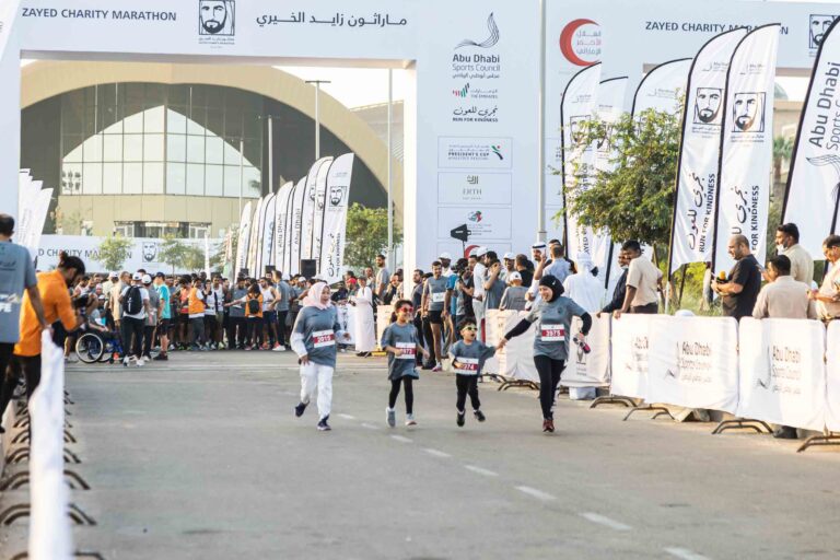 Mother running with her children at Zayed Charity Marathon Abu Dhabi 2022