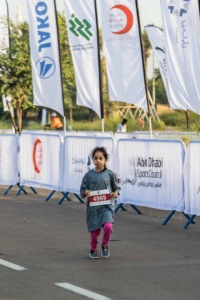 Child running in the Zayed Charity Marathon Abu Dhabi 2022